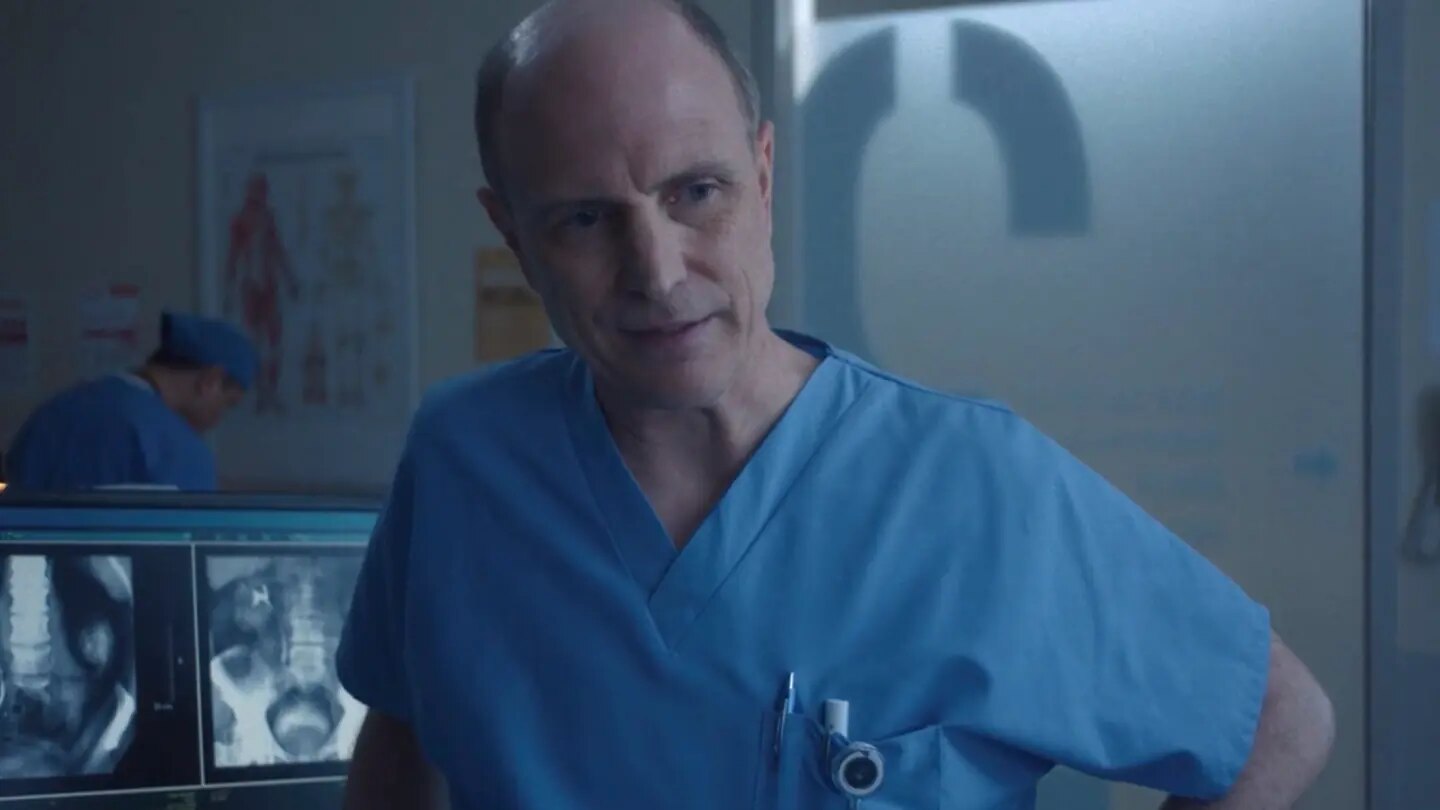 Drew Moore as Dr. Son explaining the medical findings