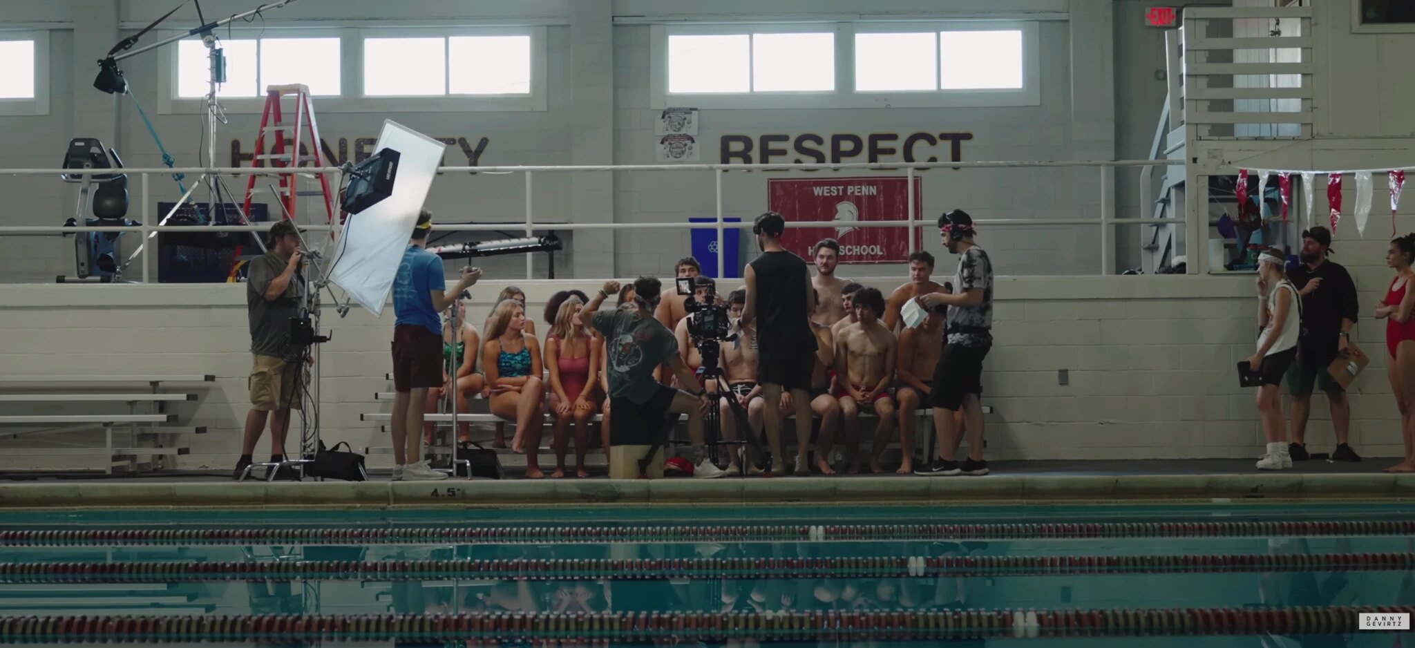 Cast and camera crew filming beside the swimming pool