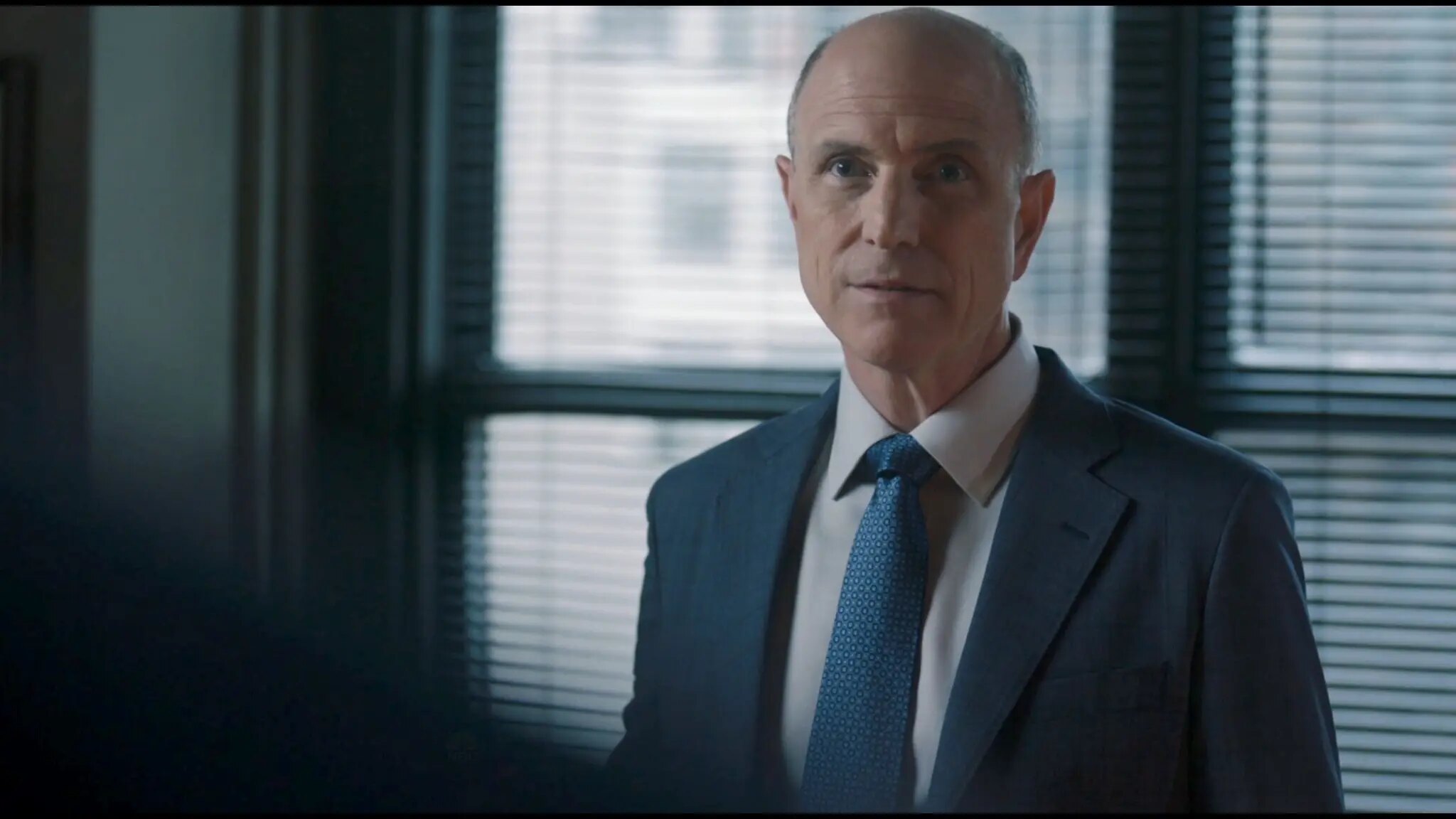 Drew Moore as Brian White speaking in his office