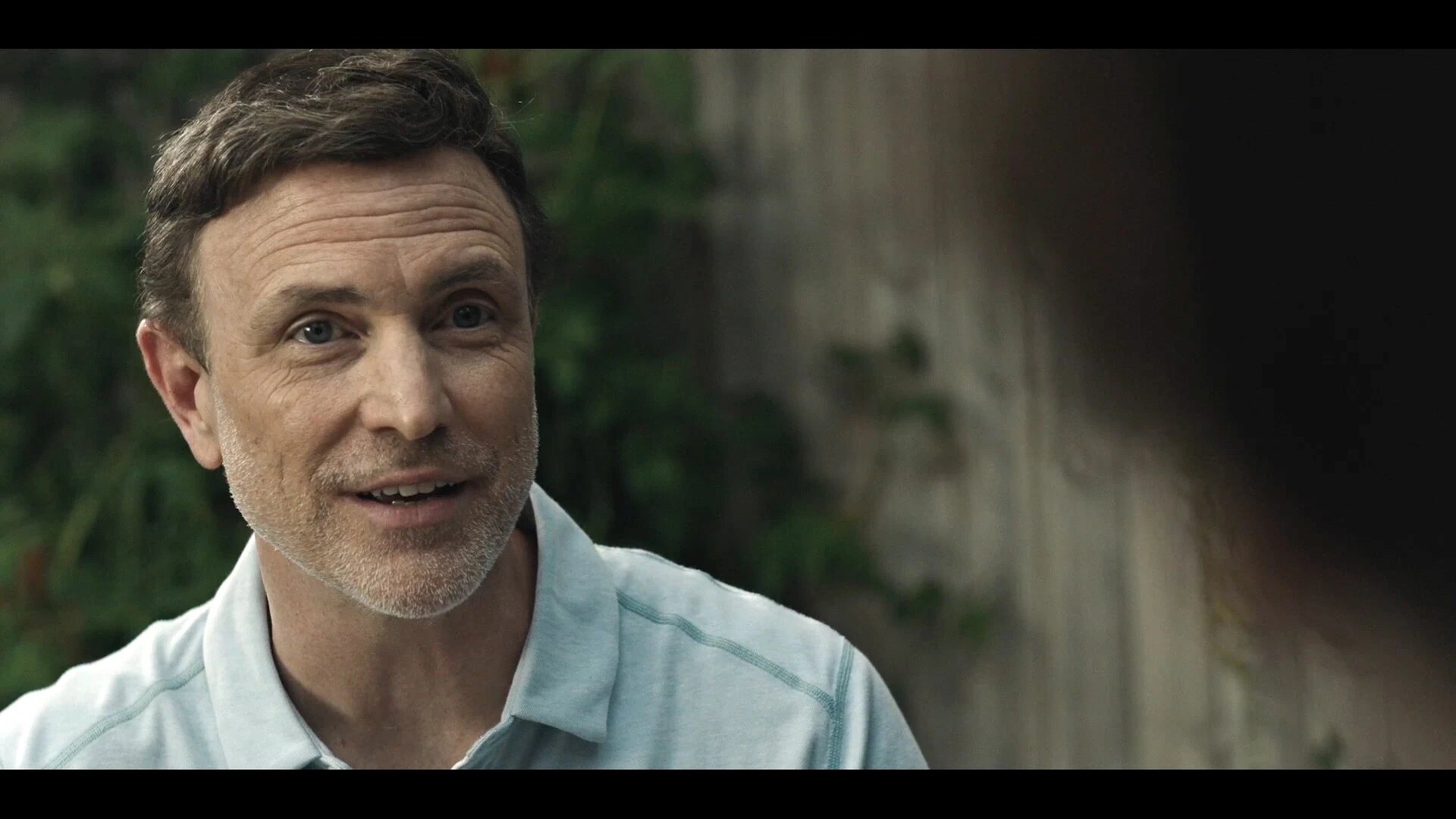 Drew Moore as Mark, speaking across the breakfast table