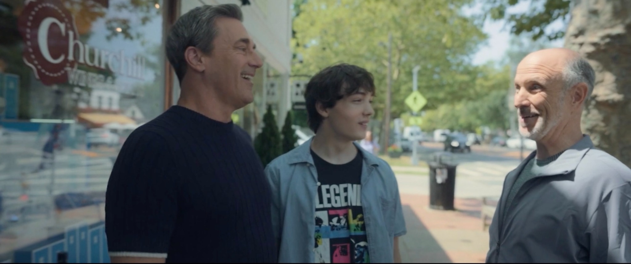 Jon Hamm as Andrew Coop Cooper, Donovan Colan as Hunter Cooper, and Drew Moore as Bosley outside a shop